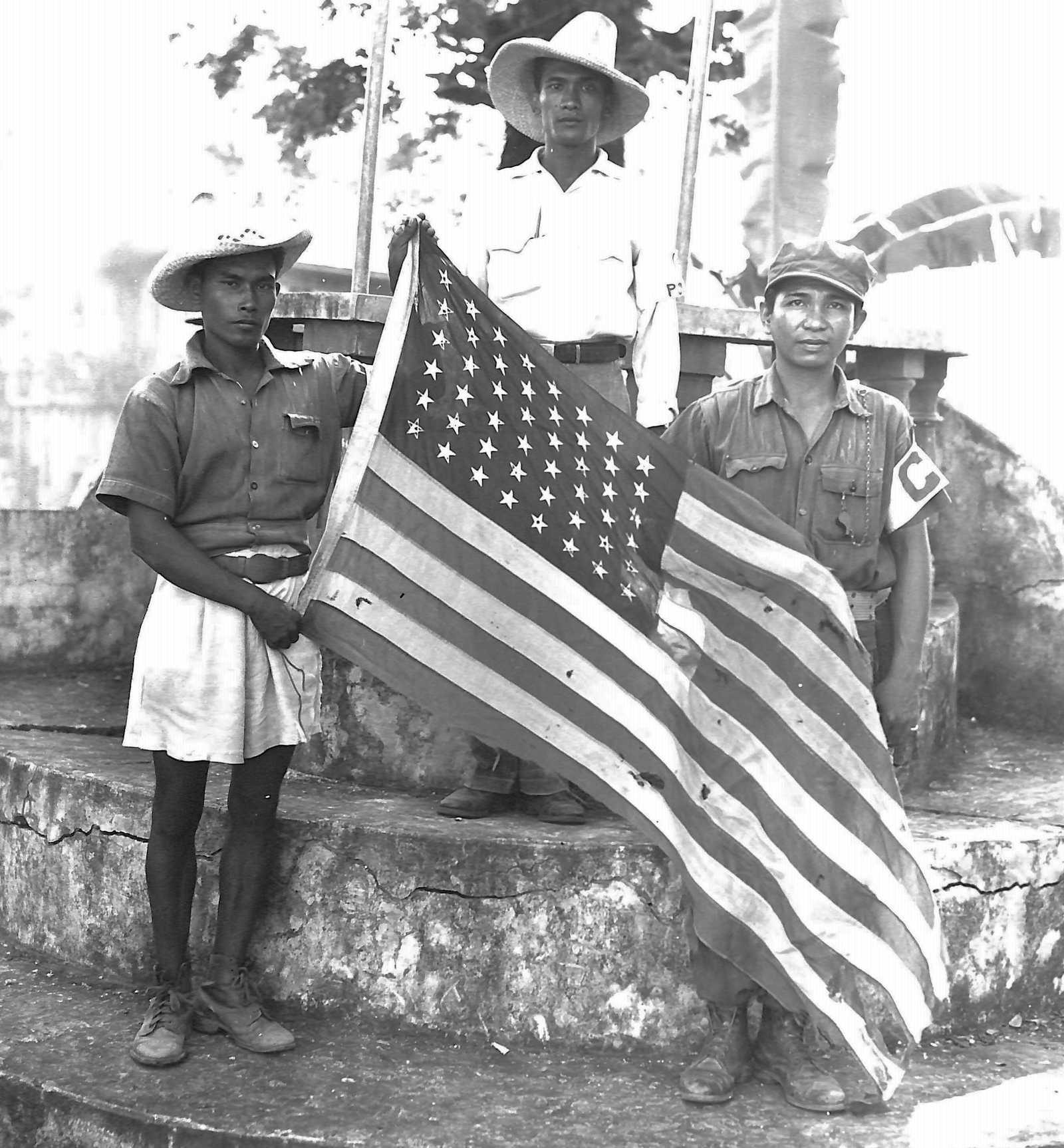 Filipino Guerrilla soldiers holding the American flag